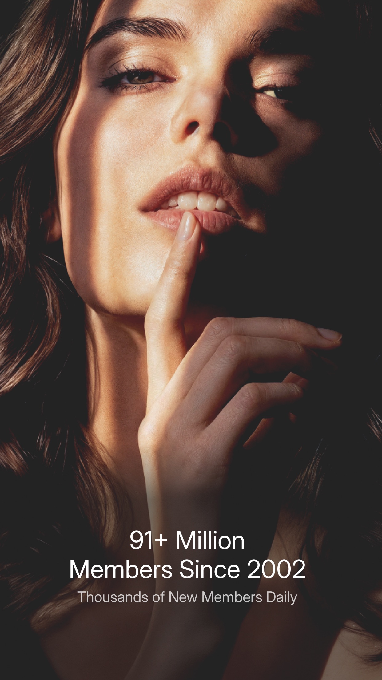 Close portrait with a finger held to the lips